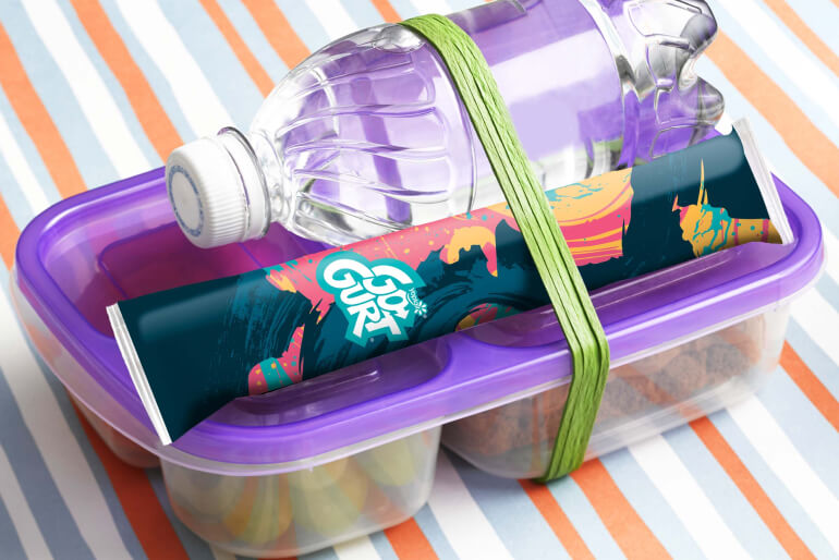 Packed lunch box with a Go-GURT tube and bottle of water attached to the top.